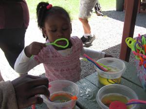 The STEM Mentor Program table and hands-on science experiment at the BBBS Summer Picnic.